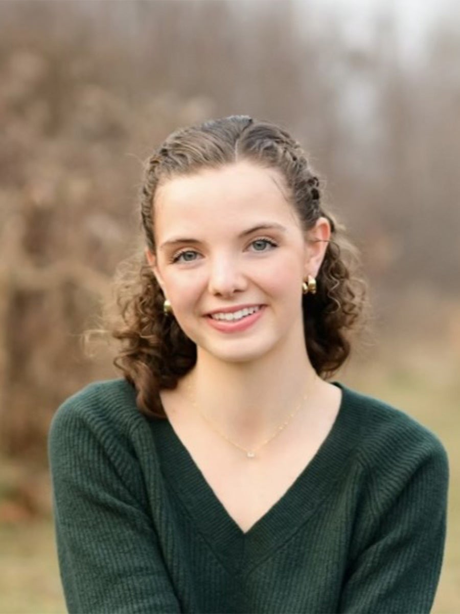 Esther Bonney's headshot where she's smiling in a green sweater 