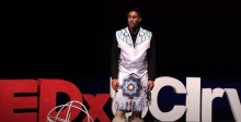 image of Native American speaker at a TED talk
