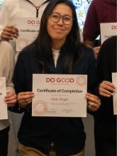 Addie singer's headshot features her holding up a certificate with the words Do Good and her name on the certificate.