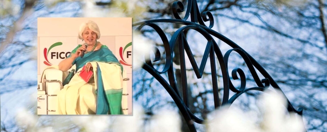 Headshot of Isher Ahluwalia, background is M gate with flowers