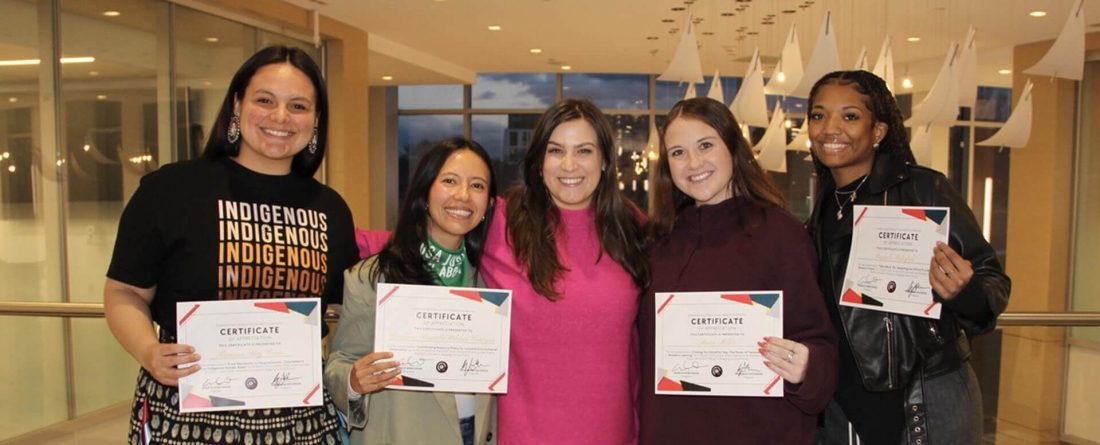5 women standing next to each other
