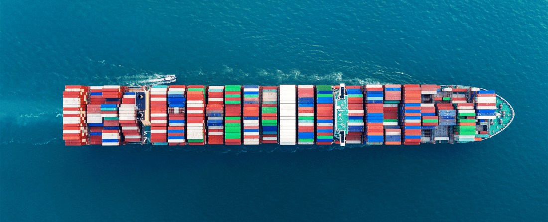 A birds-eye-view of a large cargo ship with many colorful units.