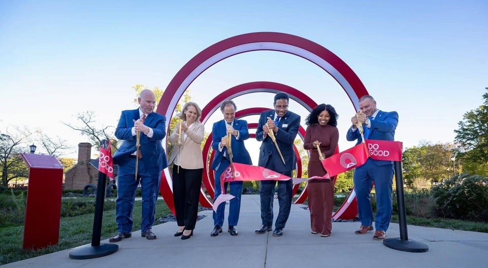 people cutting ribbon at ceremony unveiling do good rings
