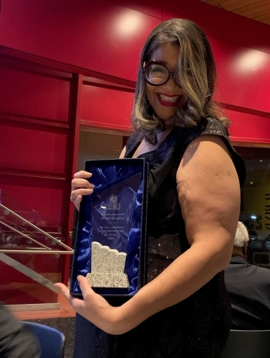 image of Brandi Slaughter holding her Malcolm Funn award